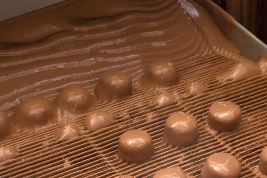 Vasilow's chocolate enrobing machine in action